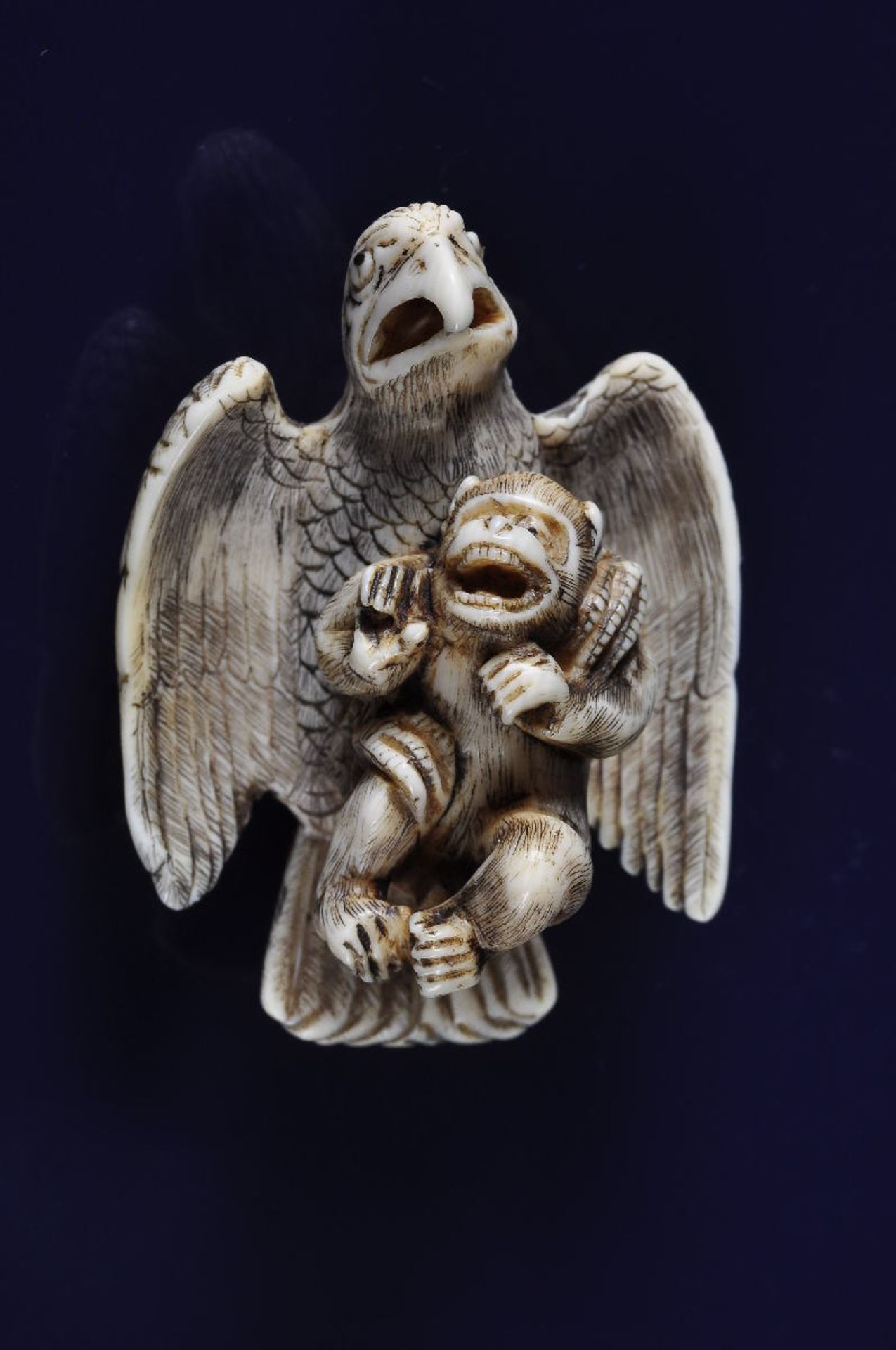 KIYOZUMI: A DRAMATIC SCENE OF AN EAGLE CATCHING A MONKEY  Netsuke, ivory. Japan, 19th cent.  The