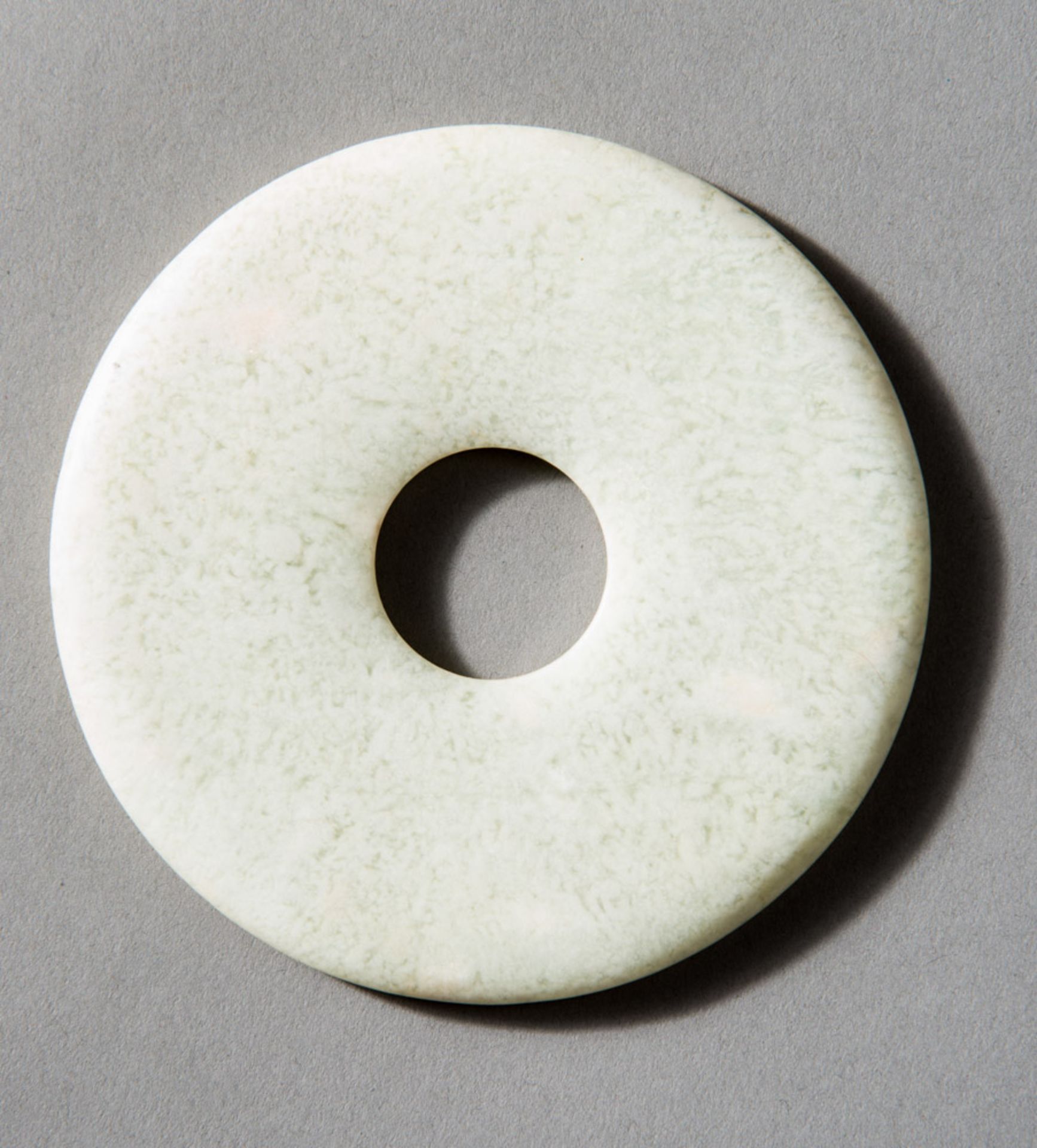 BI DISC  Jade (Nephrit), China, late Qing, ca 19th century  A disc of white jade Baiyu ?? (generally