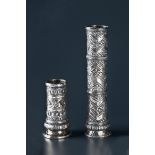 TWO SILVER CUFFS  Silver, repoussé. Java, 19th to 20th cent.  Both cuffs of tubular form, bottomless