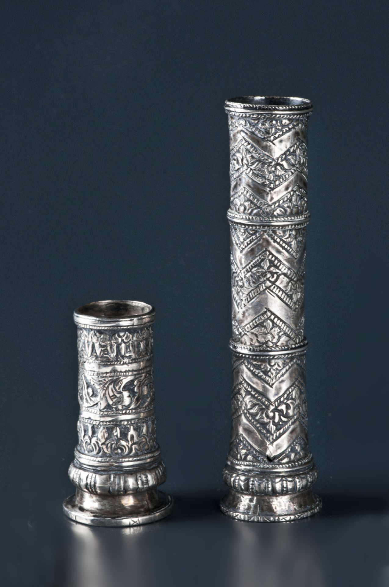 TWO SILVER CUFFS  Silver, repoussé. Java, 19th to 20th cent.  Both cuffs of tubular form, bottomless