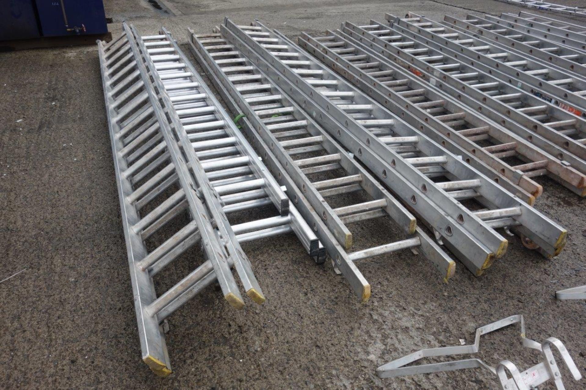 15 ladders as lotted: Four x 4m double extension ladders with wheels (each ladder making 8m in - Image 2 of 7