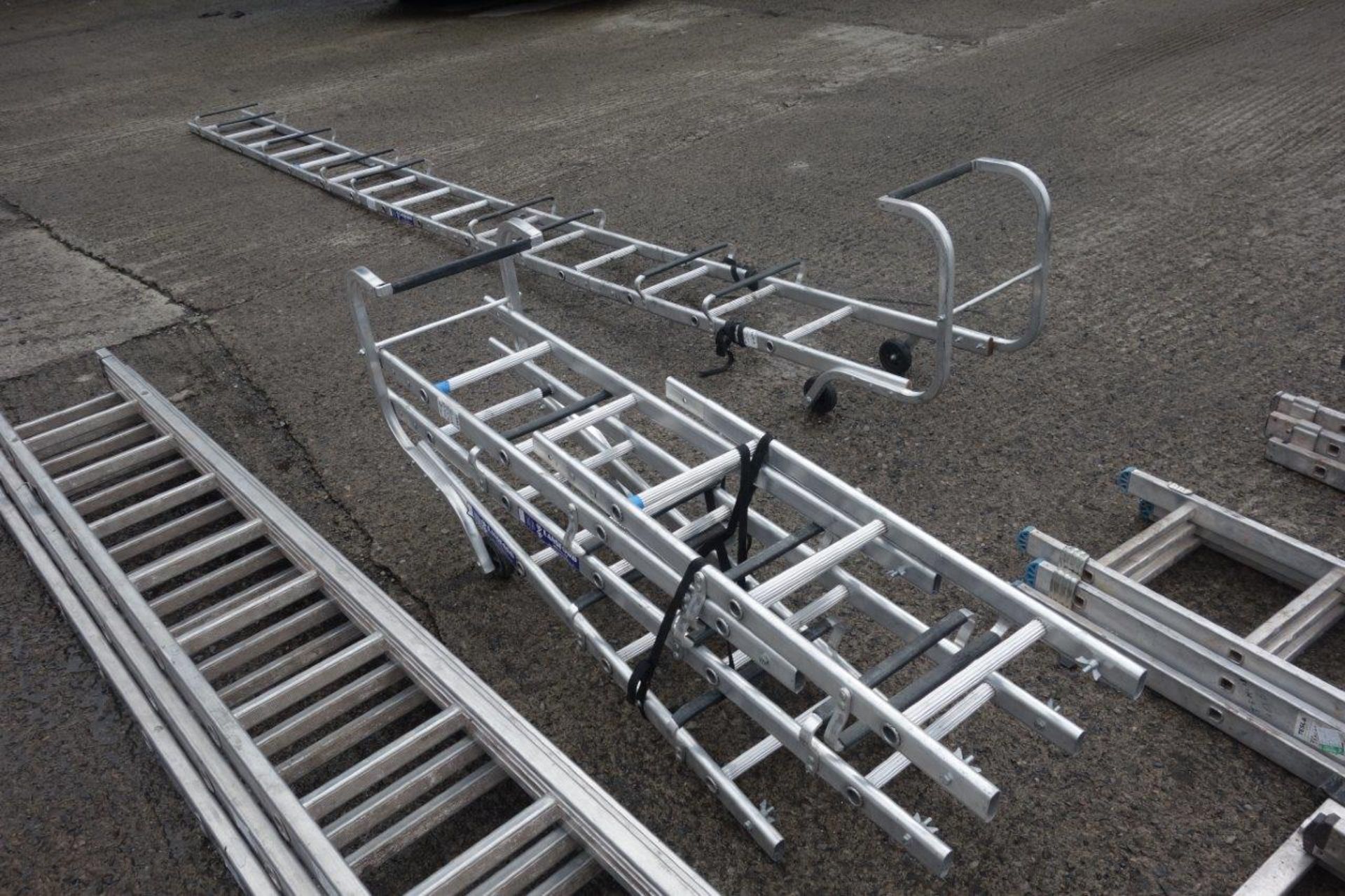 15 ladders as lotted: Four x 4m double extension ladders with wheels (each ladder making 8m in - Image 5 of 7