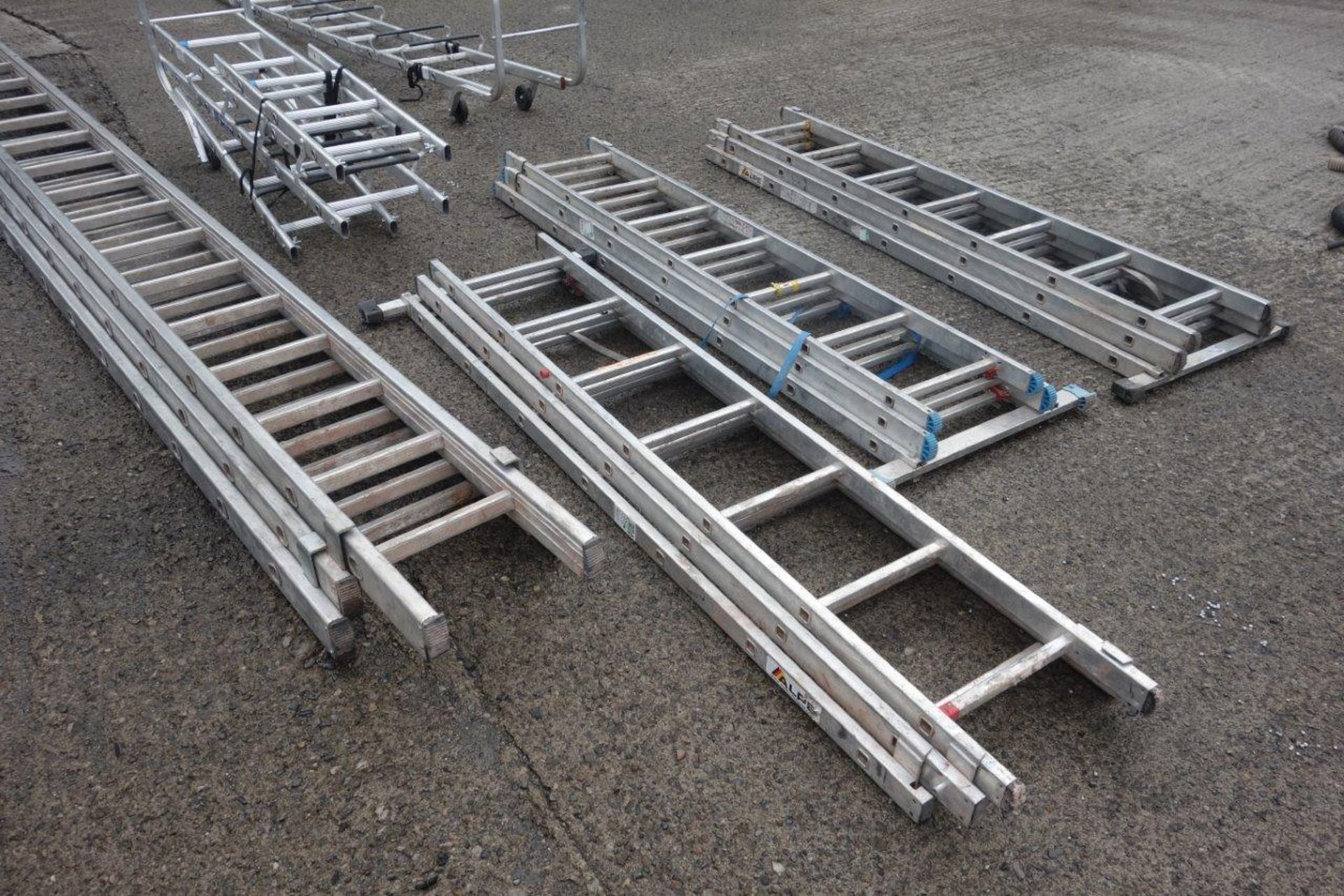 15 ladders as lotted: Four x 4m double extension ladders with wheels (each ladder making 8m in - Image 4 of 7