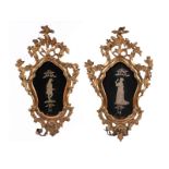 Pair of Rococo mirrors92 x 51 cm. 18th century. Carved giltwood. Restored with minimal damage, one