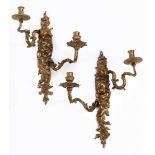 Pair of gilt-bronze twin-light wall appliques with mask decorationLength: 43 cm. Gilt-bronze.