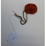 A Chinese red jade carved pendant of a m