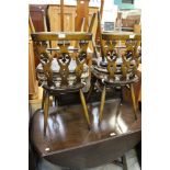 An Ercol elm topped dining table; togeth