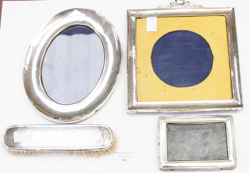 Three silver photo frames and clothes br