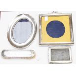 Three silver photo frames and clothes br