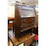 An oak gateleg table, a small oak bureau