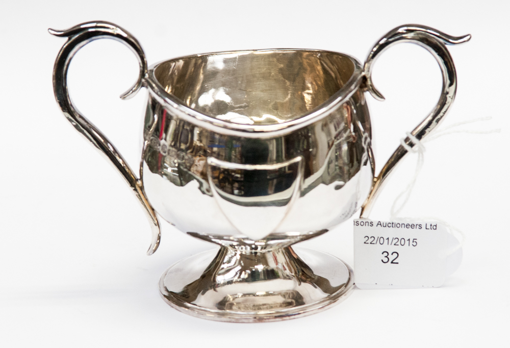 A silver two handled cup, with a vacant