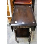 An oak drop leaf tea trolley of two tier