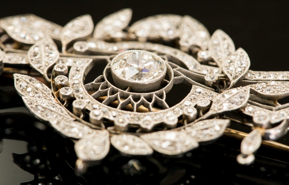 A Belle Epoque platinum and diamond brooch, of leaf and geometric form, the central stone approx - Image 2 of 2