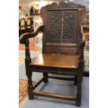 A 17th century oak wainscot chair, having a shaped crest rail and shaped ear pieces, a lozenge