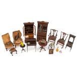 A collection of Edwardian dolls house furniture and furnishings, including Chippendale style chairs