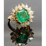 An 18ct yellow gold, emerald and diamond cluster ring, the central square-cut emerald approx 5cts,