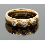 An 18ct gold and diamond three-stone ring, ring size L