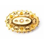 A Victorian gilt metal oval brooch, set