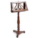 A William IV rosewood music stand, circa 1835, double sided open lyre rests with brass stringing,