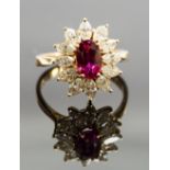 An 18ct gold, ruby and diamond cluster ring, set with an oval-cut ruby approx 1.60ct, surrounded