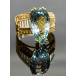 An 18ct gold, aquamarine and diamond cocktail ring, set with a large pear-cut aquamarine, flanked by