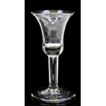 An 18th century wine glass, the bell shapped bowl with tear drop inclusion running into the plain