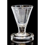 An 18th century toasting glass, the conical bowl on short stem and flanged foot, 9cm high