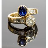 A sapphire and diamond two-stone twist ring, centre diamond approx 1.60cts, opposite an oval-cut