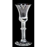 An 18th century wine glass, the bell shaped bowl on a multi spiral aritwist stem with central