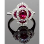 A platinum, ruby and diamond ring, set with cushion-cut and calibre-cut rubies approx 1.43ct total,