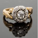 A 19th century diamond cluster ring, set with an old-cut stone surrounded by ten smaller, total