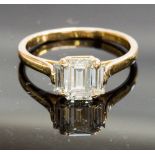 An 18ct gold and diamond three-stone ring, set with baguette-cut stones, centre diamond 1.30cts,
