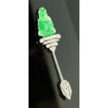 An Art Deco jadeite and diamond jabot stick pin, carved figure seated above four rows of diamonds,