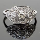 An 18ct white gold Art Deco style diamond ring, set with three graduated stones, surrounded by