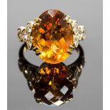 An 18ct gold, citrine and diamond cocktail ring, the faceted oval citrine approx 10cts, flanked by