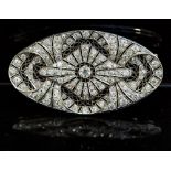 A Belle Epoque platinum and diamond plaque brooch, millegrain set graduated old-cut stones, 6.5cm