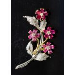 An 18ct gold, ruby and diamond floral spray brooch, set with round brilliant-cut diamonds