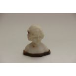 A carved white marble bust of a girl, on Sienna marble base, signed indistinctly and inset with a