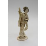A 19th century carved ivory figure of a Geisha holding a lantern and basket, 17.5cm high