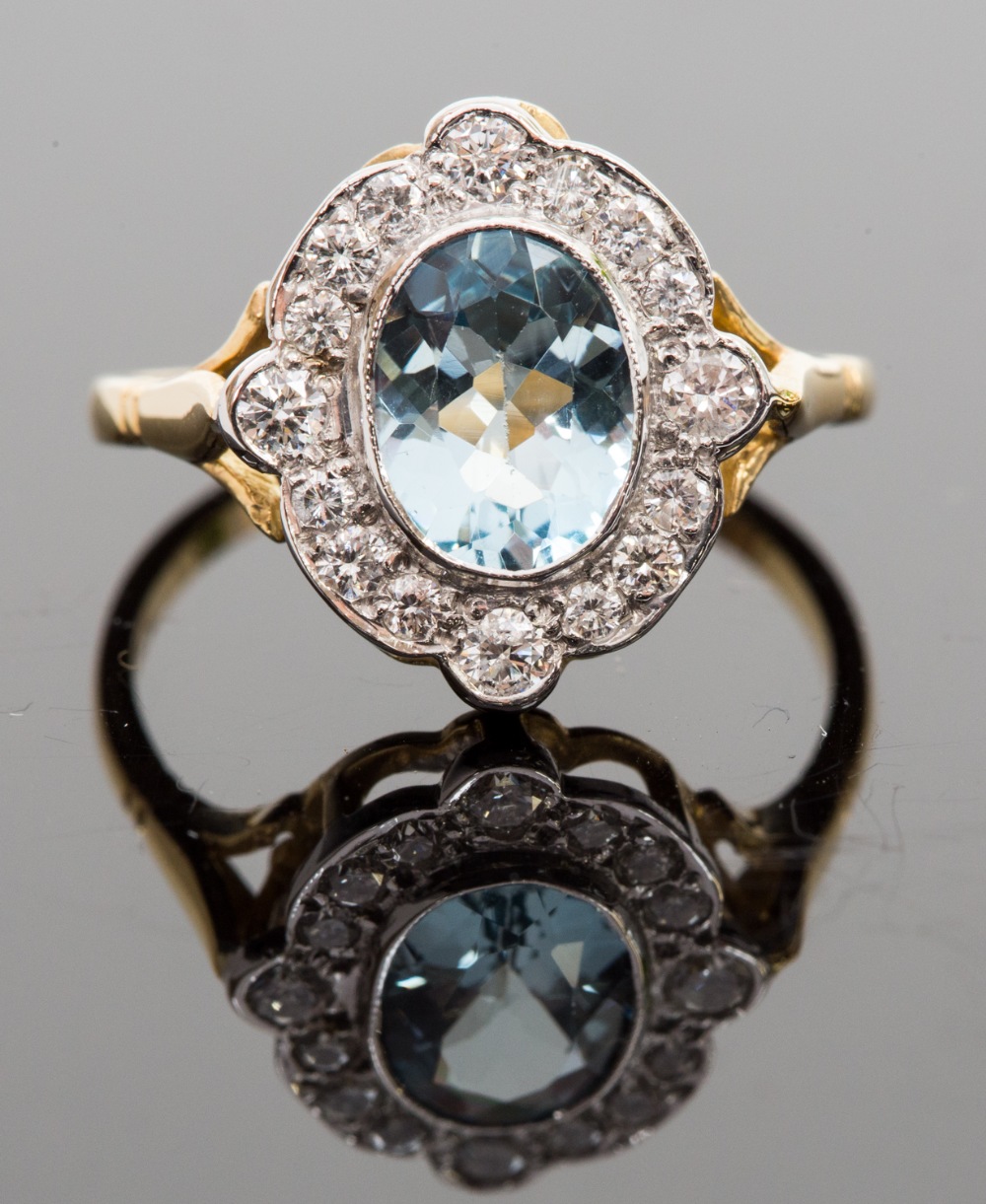 An 18ct gold, aquamarine and diamond ring, set with an oval-cut aqua approx 1.55ct, surround by