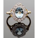 An 18ct gold, aquamarine and diamond ring, set with an oval-cut aqua approx 1.55ct, surround by