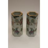 A pair of Chinese hexagonal section hat stands, famille rose, decorated with figural designs and