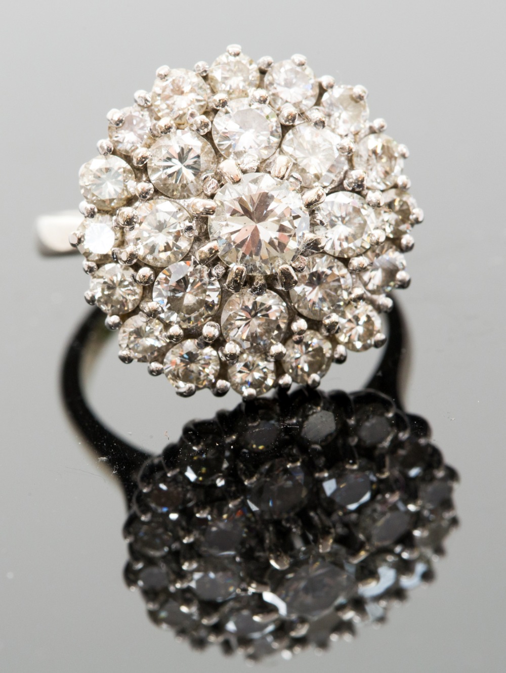 **amended total diamond weight** A diamond cluster ring, set with twenty-five graduated round