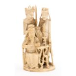 A 19th century Chinese carved ivory figure group of warriors, one seated reading a book, 13.5cm