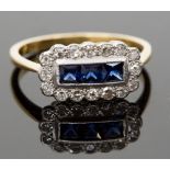 An 18ct gold sapphire and diamond ring, set with three calibre-cut sapphires surrounded by