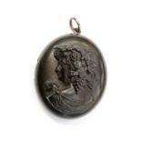 A 19th century jet cameo locket, carved in high relief depicting a Bacchant, the inside engraved