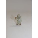 A small carved jade figure of a man with