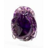 A Chinese carved amethyst pendant, in the form of a peach with leaves and branches, 5cm long