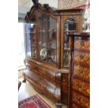 A Dutch marquetry inlaid bookcase, late 18th century, of bombe form, decorated throughout with