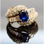 An 18ct gold, sapphire and diamond dress ring, set with an oval-cut sapphire, baguette and round